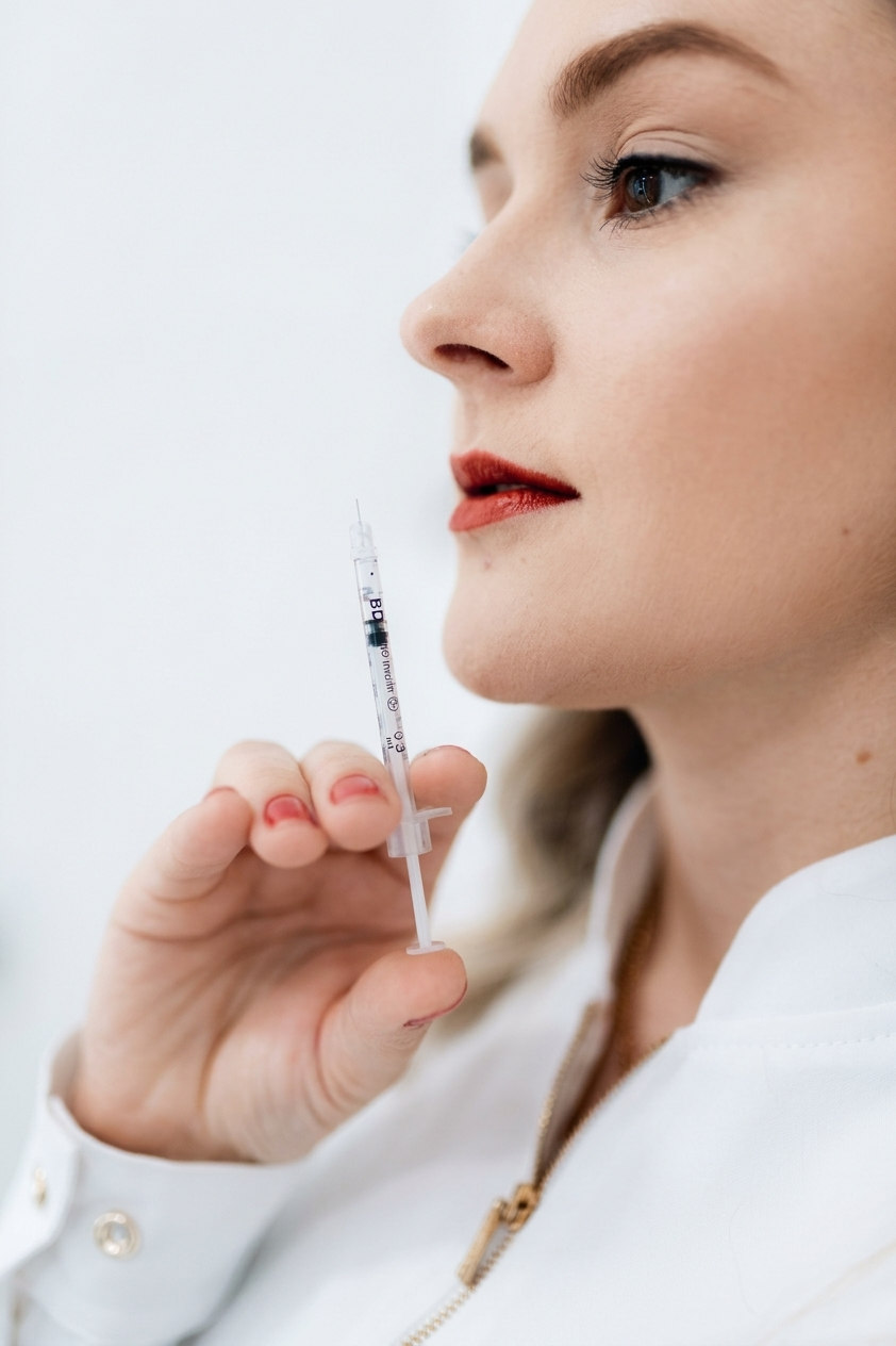 Aesthetic treatment concept: close-up portrait with a syringe